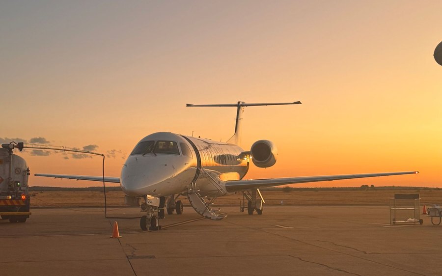Private business jet on the tarmac at sunset